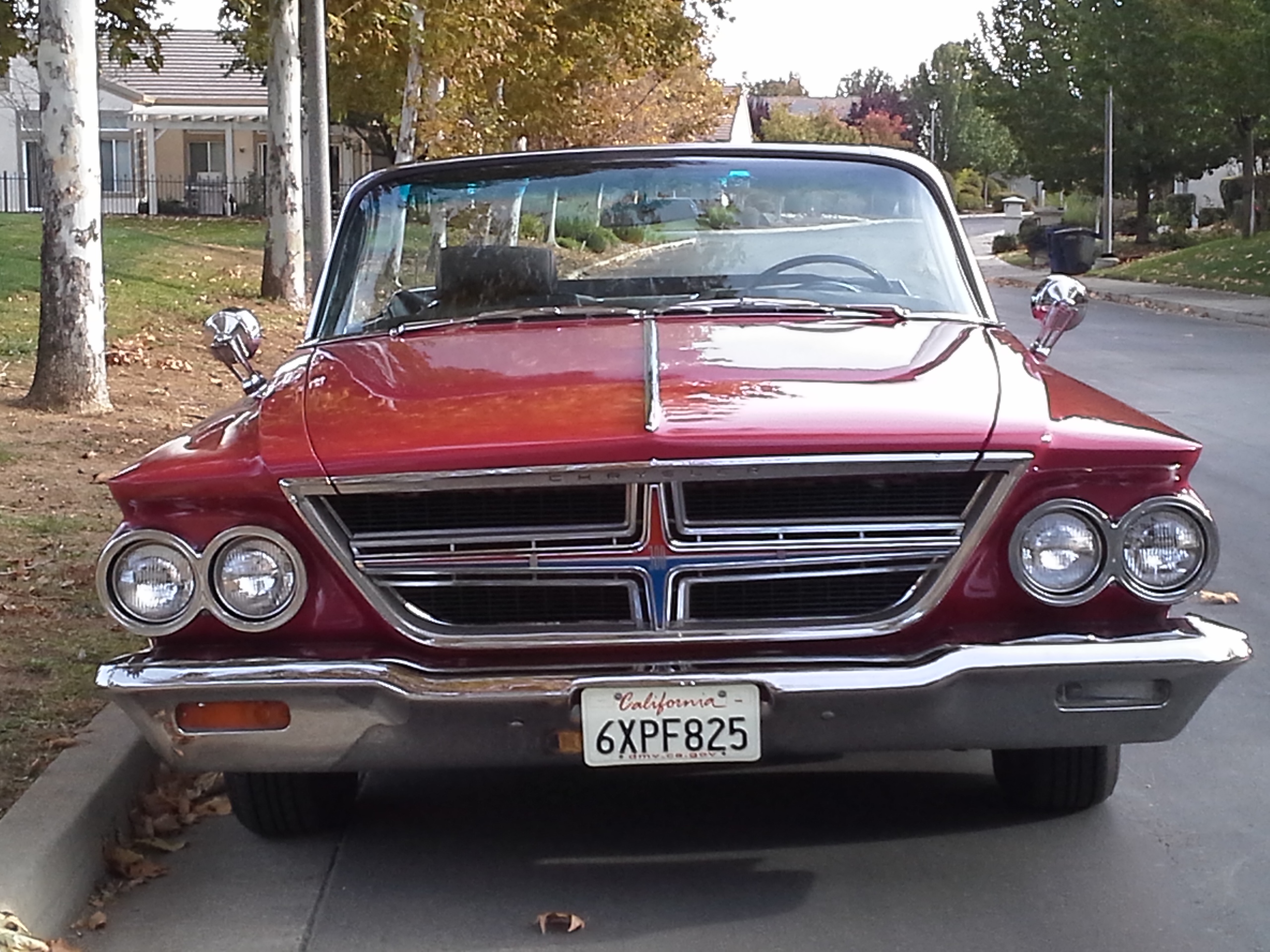 A red car parked on the side of the road

Description automatically generated with medium confidence